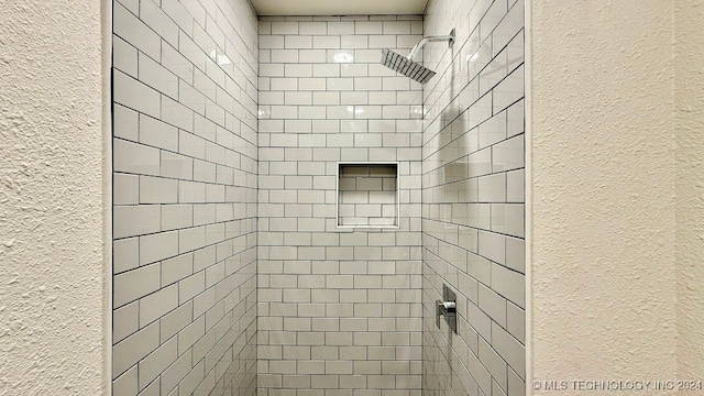 bathroom with a tile shower