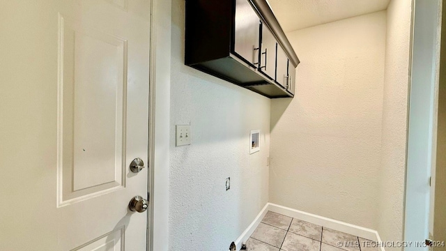 laundry room featuring cabinets, light tile patterned floors, and hookup for a washing machine