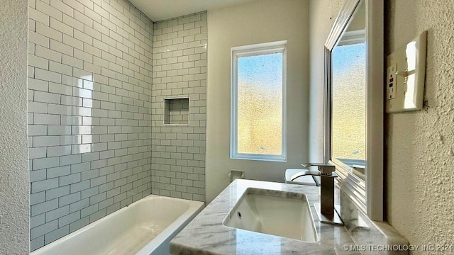 bathroom with a wealth of natural light and sink