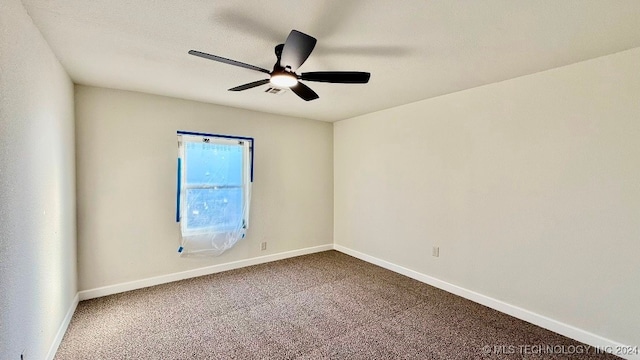 unfurnished room featuring ceiling fan and carpet floors