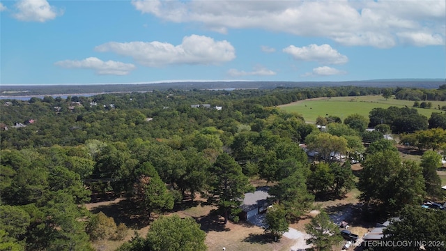 birds eye view of property with a view of trees