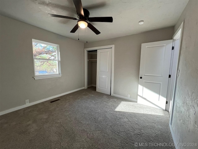 unfurnished bedroom featuring baseboards, a closet, visible vents, and carpet flooring