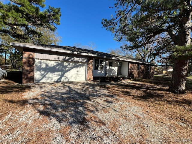 exterior space with a garage, driveway, and brick siding