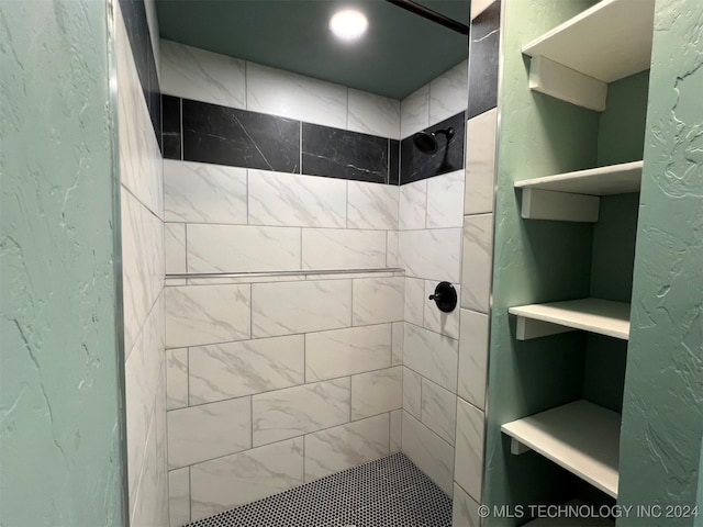 bathroom featuring a stall shower and a textured wall