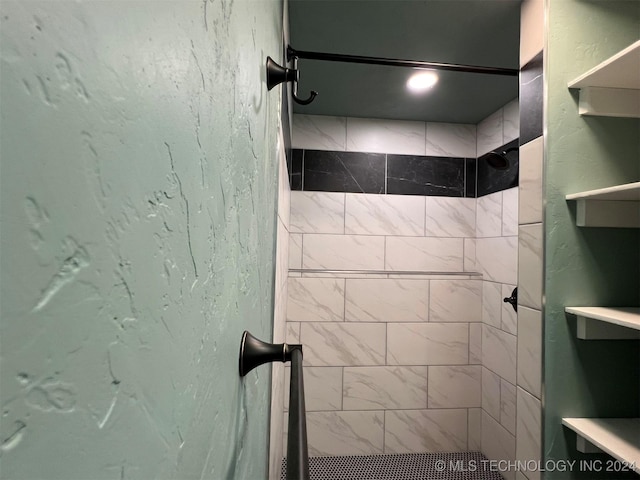 full bath with a textured wall and a stall shower