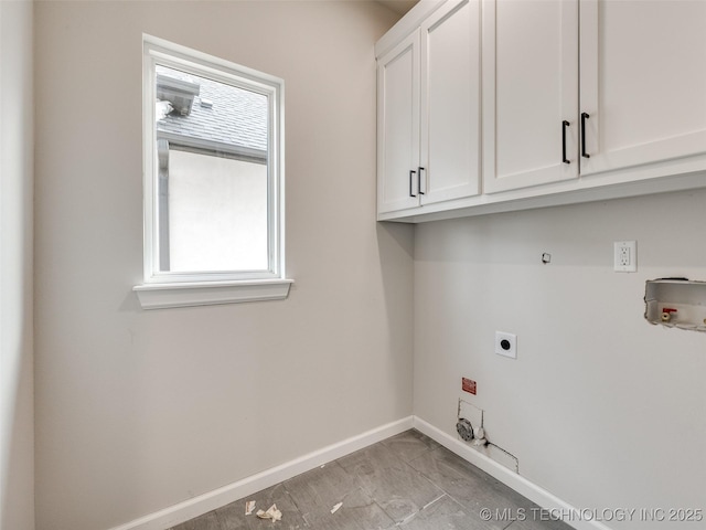 clothes washing area with washer hookup, cabinets, a wealth of natural light, and hookup for an electric dryer