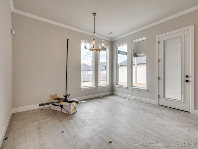 unfurnished dining area featuring crown molding and a notable chandelier