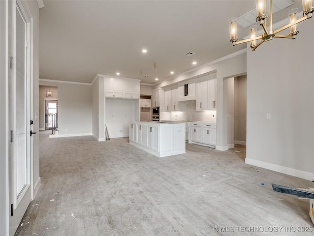 kitchen with white cabinetry, crown molding, pendant lighting, and a center island