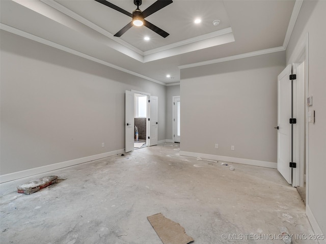 spare room featuring crown molding, ceiling fan, and a tray ceiling