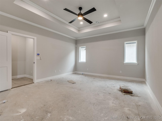 spare room with ceiling fan, ornamental molding, and a raised ceiling