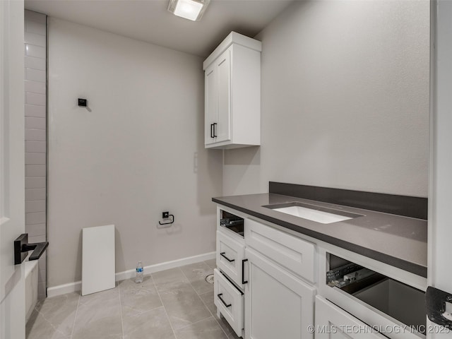 interior space with sink and light tile patterned flooring