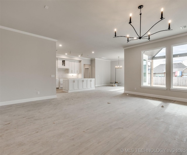 unfurnished living room featuring light hardwood / wood-style floors, crown molding, and an inviting chandelier