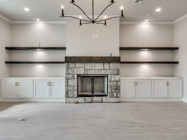 unfurnished living room featuring light wood-type flooring, ornamental molding, and a fireplace