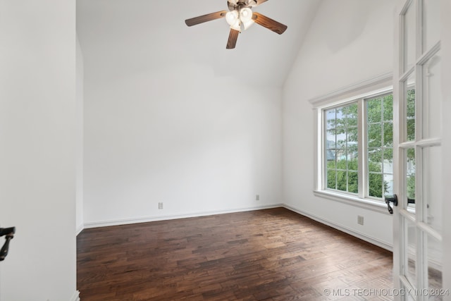 spare room featuring ceiling fan, dark wood-type flooring, and high vaulted ceiling