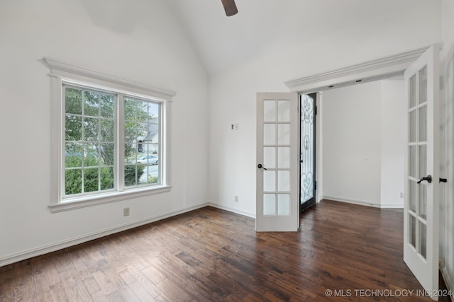 spare room featuring dark hardwood / wood-style flooring, ceiling fan, french doors, and high vaulted ceiling