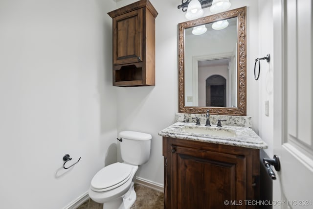 bathroom featuring tile patterned floors, vanity, and toilet