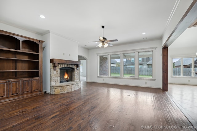 unfurnished living room featuring dark hardwood / wood-style floors, a fireplace, and a wealth of natural light