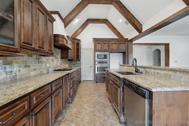 kitchen featuring vaulted ceiling with beams, decorative backsplash, light stone counters, and appliances with stainless steel finishes