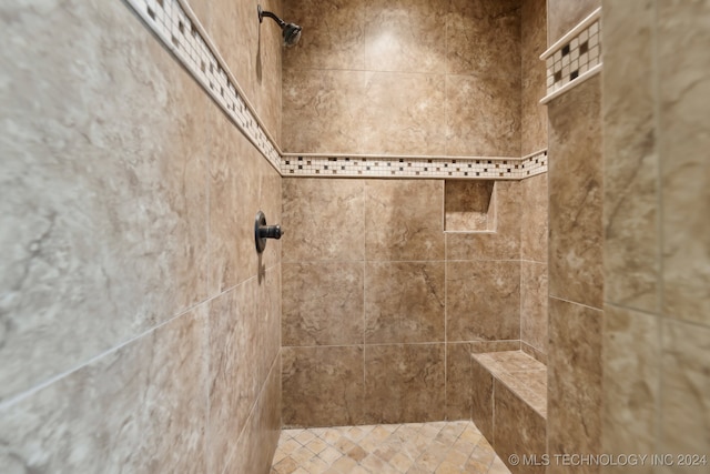 bathroom with a tile shower