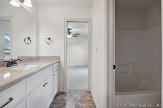 bathroom featuring vanity, ceiling fan, and a shower