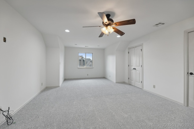 interior space with light colored carpet and ceiling fan