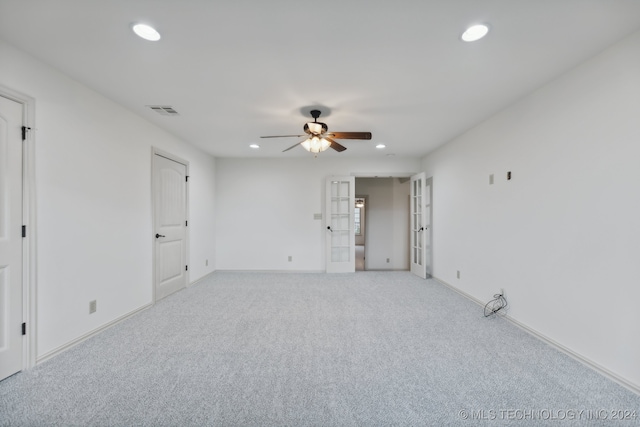 carpeted spare room with french doors and ceiling fan