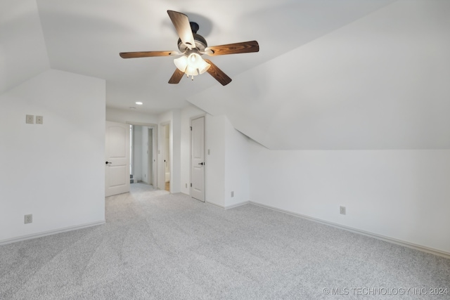 additional living space featuring light carpet, vaulted ceiling, and ceiling fan