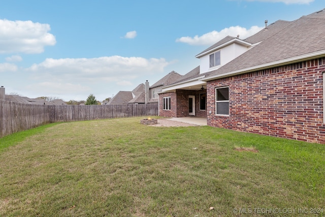 view of yard with a fire pit and a patio