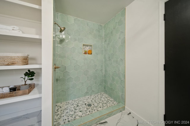 bathroom with tiled shower