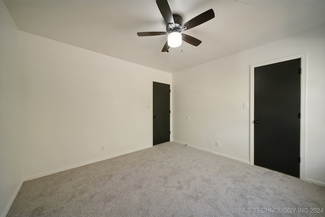 unfurnished room featuring ceiling fan and light carpet