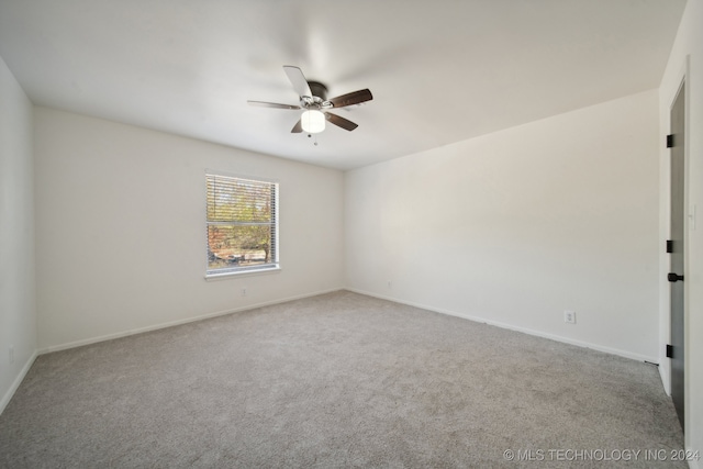 empty room featuring light colored carpet and ceiling fan