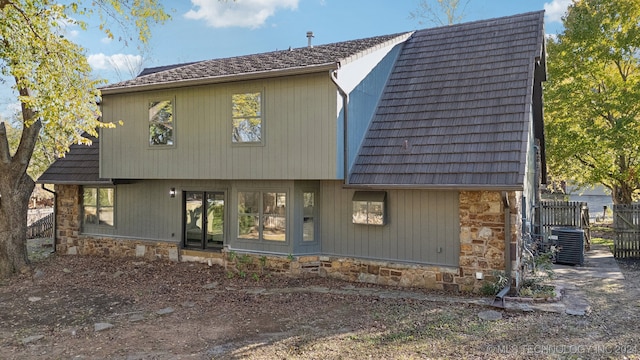 rear view of property with central AC unit