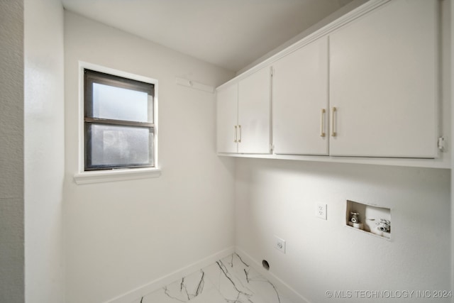 laundry room with electric dryer hookup, hookup for a washing machine, and cabinets