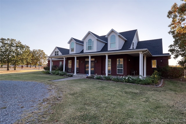 new england style home with a front lawn and a porch