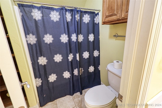 bathroom with tile patterned floors and toilet