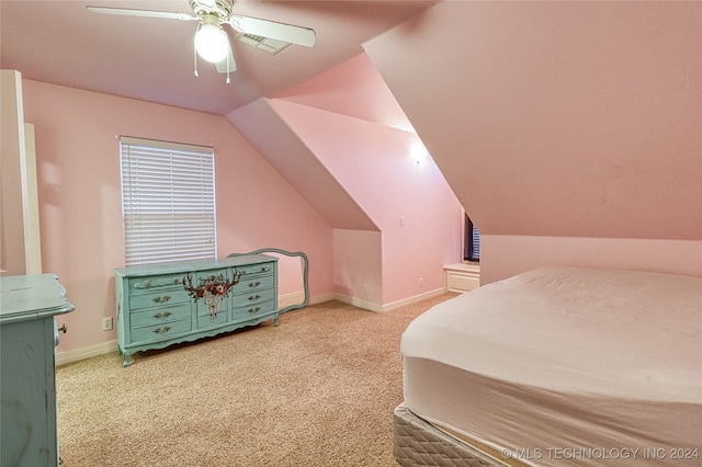 bedroom with ceiling fan, light colored carpet, and vaulted ceiling