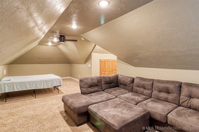 cinema featuring a textured ceiling, carpet floors, and lofted ceiling