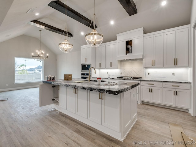 kitchen with decorative light fixtures, sink, white cabinetry, light wood-type flooring, and stainless steel appliances