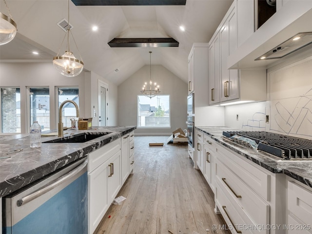 kitchen with premium range hood, white cabinets, sink, and stainless steel appliances