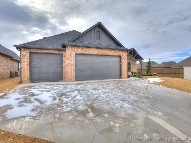 view of front of home featuring central AC and a garage