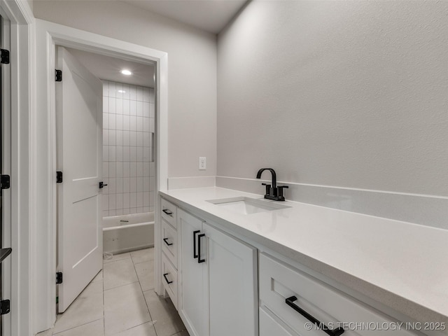 bathroom with vanity, tile patterned floors, and tiled shower / bath