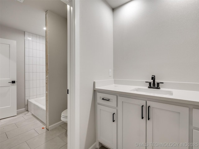 full bathroom featuring toilet, tile patterned flooring, tiled shower / bath, and vanity