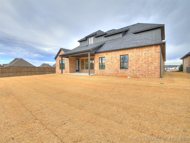 rear view of house featuring central AC unit and a patio area