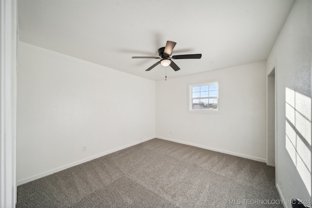 empty room with ceiling fan and carpet