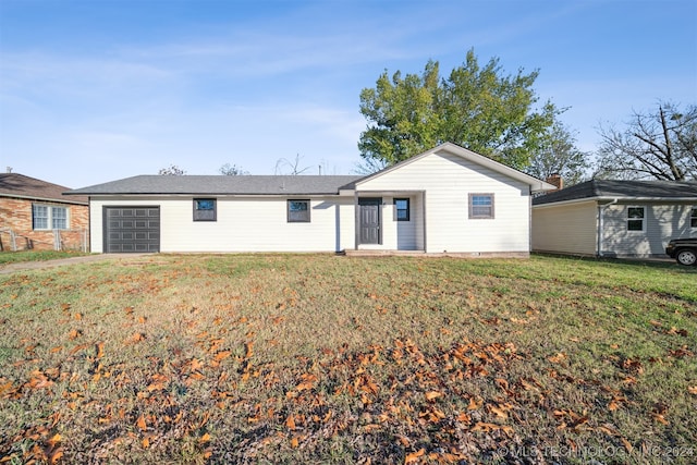 rear view of property featuring a lawn