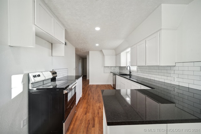 kitchen featuring appliances with stainless steel finishes, dark hardwood / wood-style flooring, a textured ceiling, sink, and white cabinets