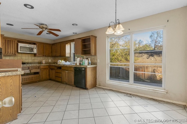 kitchen featuring pendant lighting, backsplash, ceiling fan with notable chandelier, light tile patterned floors, and stainless steel appliances