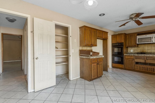 kitchen featuring backsplash, ceiling fan, light tile patterned floors, and appliances with stainless steel finishes