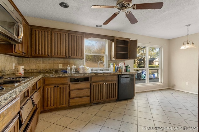 kitchen with appliances with stainless steel finishes, backsplash, hanging light fixtures, and sink