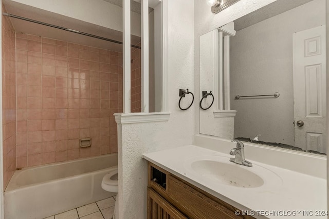 full bathroom with tile patterned floors, tiled shower / bath combo, toilet, and vanity